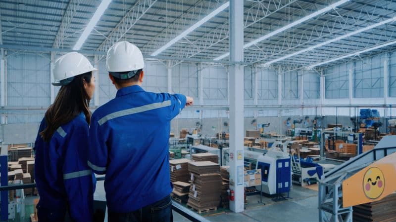Industrial Engineers Overlooking Factory Operations From Above